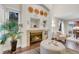 Charming living room features a fireplace, hardwood floors, stylish furniture, and a large plant at 4112 Brandon Ave, Broomfield, CO 80020