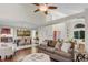 Open living space featuring vaulted ceilings, hardwood floors, comfortable seating, dining area, and an orange entry door at 4112 Brandon Ave, Broomfield, CO 80020