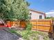 Backyard featuring a privacy fence and beautiful mature landscaping at 1288 S Beeler Ct, Denver, CO 80247