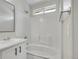 Bathroom with a bathtub and shower combination, white subway tile and modern fixtures with natural lighting at 1288 S Beeler Ct, Denver, CO 80247
