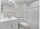 Bathroom features a single sink vanity, tub and shower combo and decorative mirror with lighting at 1288 S Beeler Ct, Denver, CO 80247