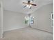 Bedroom with tall ceiling, carpet, ceiling fan and a bright window offering ample natural light at 1288 S Beeler Ct, Denver, CO 80247