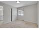 Bedroom with carpet, closet with sliding doors, and window to the neighborhood at 1288 S Beeler Ct, Denver, CO 80247