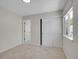 Bright bedroom with carpet, closet with sliding doors, and window to the neighborhood beyond at 1288 S Beeler Ct, Denver, CO 80247