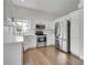 Bright kitchen featuring stainless steel appliances, white cabinets, and ample countertop space at 1288 S Beeler Ct, Denver, CO 80247