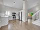 Well-lit kitchen with stainless steel appliances, white cabinets, and hardwood floors at 1288 S Beeler Ct, Denver, CO 80247