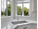 Close-up of a kitchen sink with quartz countertops and natural light from the adjacent windows at 1288 S Beeler Ct, Denver, CO 80247