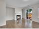 Cozy living room features hardwood flooring, a fireplace, and access to the backyard through sliding glass doors at 1288 S Beeler Ct, Denver, CO 80247