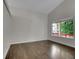 Spacious living room featuring hardwood floors, a vaulted ceiling, and a large window with outdoor views at 1288 S Beeler Ct, Denver, CO 80247