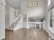 Open-concept living room featuring hardwood floors, a staircase, and a view of the fireplace at 1288 S Beeler Ct, Denver, CO 80247
