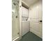 Bathroom with a stacked washer and dryer next to the glass-enclosed shower at 3260 47Th St # 205A, Boulder, CO 80301