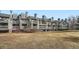 A multi-level condo building with wood siding, multiple balconies, and well-maintained lawn at 3260 47Th St # 205A, Boulder, CO 80301