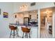 Eat-in kitchen features a breakfast bar with seating, stainless steel appliances, and a sleek countertop at 3260 47Th St # 205A, Boulder, CO 80301