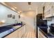 Bright kitchen with white cabinets, black appliances, and modern backsplash at 3260 47Th St # 205A, Boulder, CO 80301