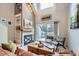 Bright living room with a fireplace, built-in shelves, and sliding glass door leading to a balcony at 3260 47Th St # 205A, Boulder, CO 80301