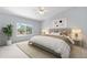Bright bedroom with neutral walls, a ceiling fan, and a large window overlooking the backyard at 19410 E Ithaca Pl, Aurora, CO 80013