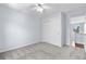 Neutral bedroom with plush carpeting, a ceiling fan, a closet and a large window at 19410 E Ithaca Pl, Aurora, CO 80013