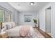 Bright bedroom with two windows, a large bed, wood floors and a decorative plant at 19410 E Ithaca Pl, Aurora, CO 80013