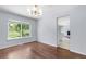 Well-lit dining space showcasing hardwood floors and a view to outdoor landscape at 19410 E Ithaca Pl, Aurora, CO 80013