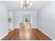Bright dining area featuring hardwood floors and a view of the living room at 19410 E Ithaca Pl, Aurora, CO 80013