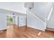 Spacious living room with hardwood floors, open layout, and views to the dining area at 19410 E Ithaca Pl, Aurora, CO 80013