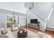 Bright living room with high ceilings and hardwood flooring, open to dining area at 19410 E Ithaca Pl, Aurora, CO 80013