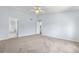 Spacious primary bedroom with neutral walls, ceiling fan and adjoining en suite bathroom at 19410 E Ithaca Pl, Aurora, CO 80013