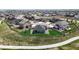 Aerial view of a gray house with a fenced backyard featuring a lawn, patio, play set, and a nearby walking path at 13488 Wabash St, Thornton, CO 80602