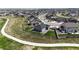 Aerial view of a gray house with a fenced backyard featuring a lawn, patio, play set, and a nearby walking path at 13488 Wabash St, Thornton, CO 80602