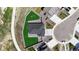 Aerial view of a gray house with a two-car garage, landscaped yard, and fenced backyard with a play set at 13488 Wabash St, Thornton, CO 80602