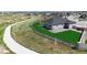 View of backyard featuring a wooden fence, lush lawn, patio, and play set next to the neighborhood walking path at 13488 Wabash St, Thornton, CO 80602