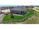 Spacious backyard features a wooden fence, lush lawn, patio, and play set, perfect for outdoor entertaining and play at 13488 Wabash St, Thornton, CO 80602