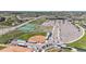Aerial view of baseball field, tennis courts, parking lot and school building in a well-planned community at 13488 Wabash St, Thornton, CO 80602
