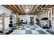 Basement workout area with rubber floors, a treadmill, weight rack and workout equipment at 13488 Wabash St, Thornton, CO 80602
