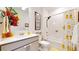 Bright bathroom featuring a white vanity, tub with shower, and whimsical duck-themed shower curtain at 13488 Wabash St, Thornton, CO 80602