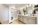 Bright bathroom featuring a glass shower with a bench and a double vanity with plants at 13488 Wabash St, Thornton, CO 80602