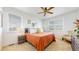 Bright bedroom with a large window, cozy furniture, and a wooden ceiling fan at 13488 Wabash St, Thornton, CO 80602