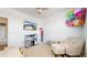 Bright bedroom with a cozy chair and play kitchen area at 13488 Wabash St, Thornton, CO 80602