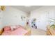 Sweet bedroom with a small wood framed bed, perfect for sleep and play at 13488 Wabash St, Thornton, CO 80602