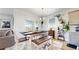 Bright dining area with rustic wood table and bench, next to sliding glass doors at 13488 Wabash St, Thornton, CO 80602