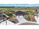 Exterior view of a gray house with a two-car garage, landscaped yard, and fenced backyard with a play set at 13488 Wabash St, Thornton, CO 80602