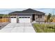 Beautiful single-Gathering home featuring a three-car garage and stone and gray siding at 13488 Wabash St, Thornton, CO 80602