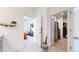 Hallway featuring access to the bedroom and walk-in closet, with tile flooring and neutral walls at 13488 Wabash St, Thornton, CO 80602