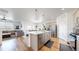 Open-concept kitchen with stainless steel appliances, seamlessly connected to the living and dining areas at 13488 Wabash St, Thornton, CO 80602