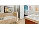 Well-lit bathroom boasts a soaking tub and a glass enclosed shower at 6292 Kilmer Loop # 201, Golden, CO 80403