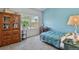 Cozy bedroom with bright blue accent wall and sunny window at 6292 Kilmer Loop # 201, Golden, CO 80403