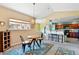 Cozy dining area with modern chandelier, breakfast bar seating, and access to the kitchen at 6292 Kilmer Loop # 201, Golden, CO 80403