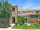 Charming townhome featuring a stone pillar, manicured lawn, and inviting outdoor seating area at 6292 Kilmer Loop # 201, Golden, CO 80403