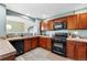 Well-equipped kitchen featuring cherry cabinets, modern appliances, and durable countertops at 6292 Kilmer Loop # 201, Golden, CO 80403