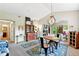 Spacious living room with access to other rooms, a modern chandelier, and ample space for furniture at 6292 Kilmer Loop # 201, Golden, CO 80403